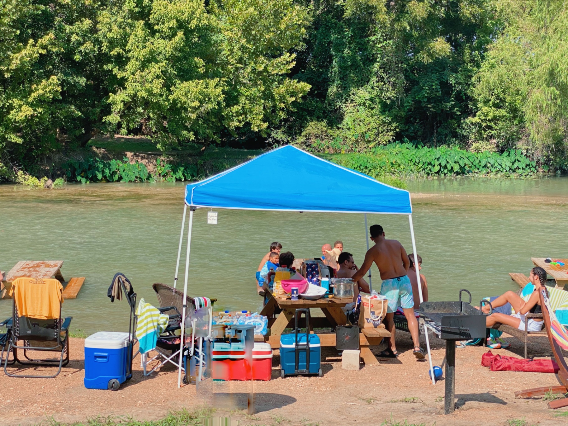 Family enjoying riverside picnic