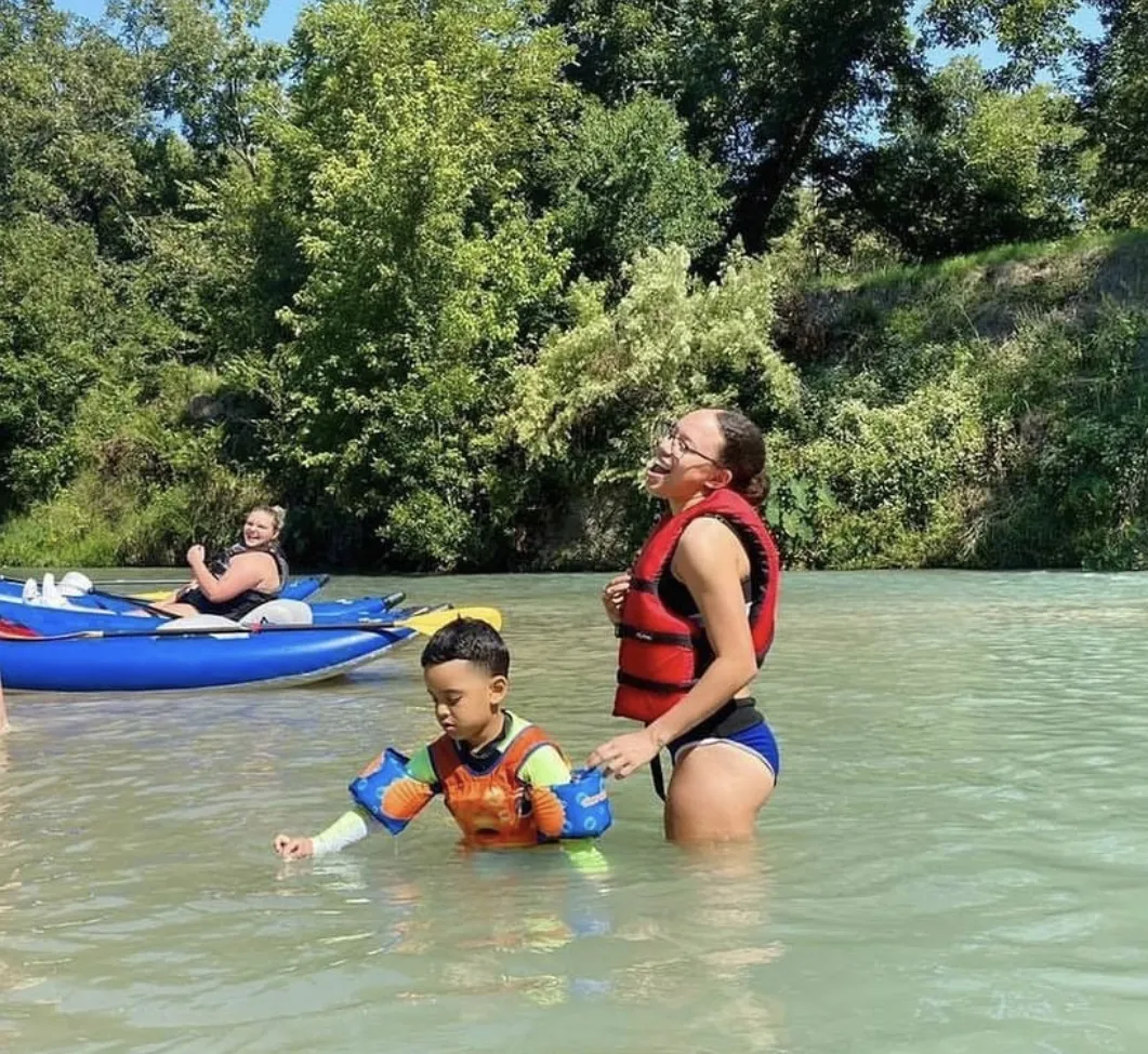 Family swimming with life vests