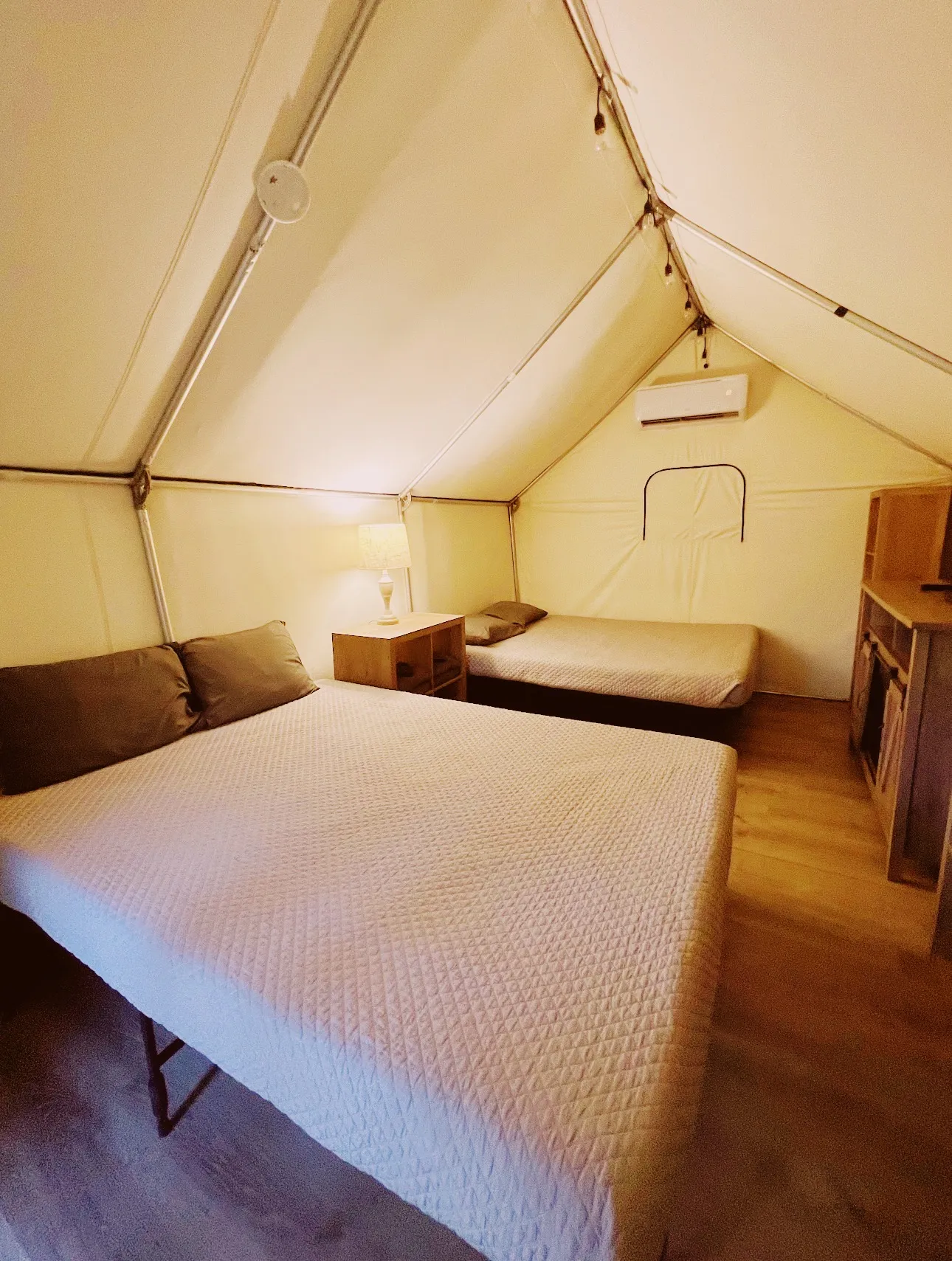 Glamping cabin interior with real beds and AC
