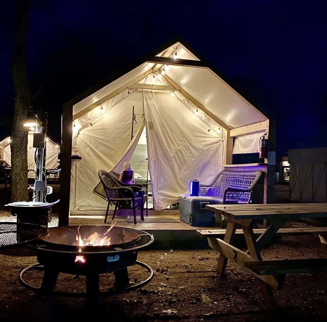 Glamping cabin lit up at night near Austin