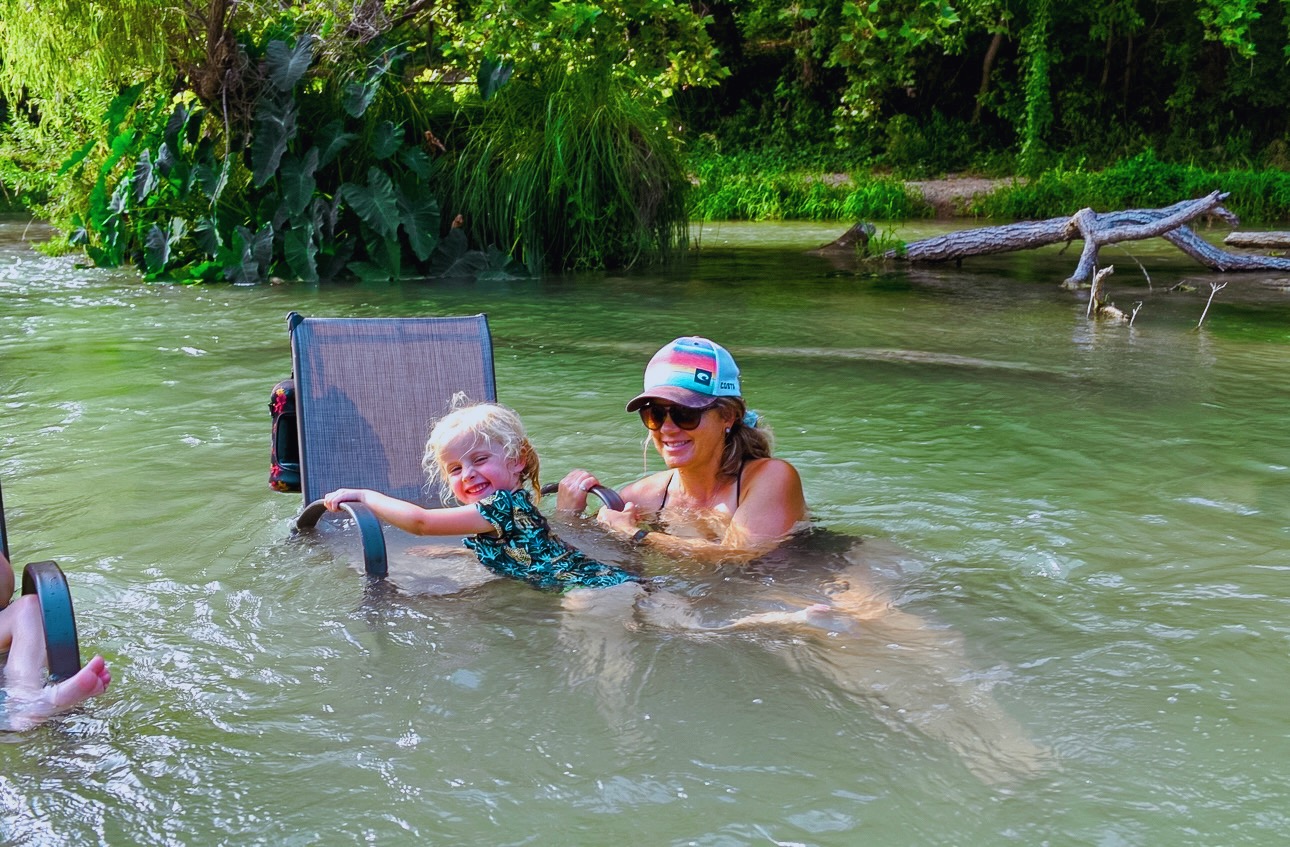 Mom and child playing in the river