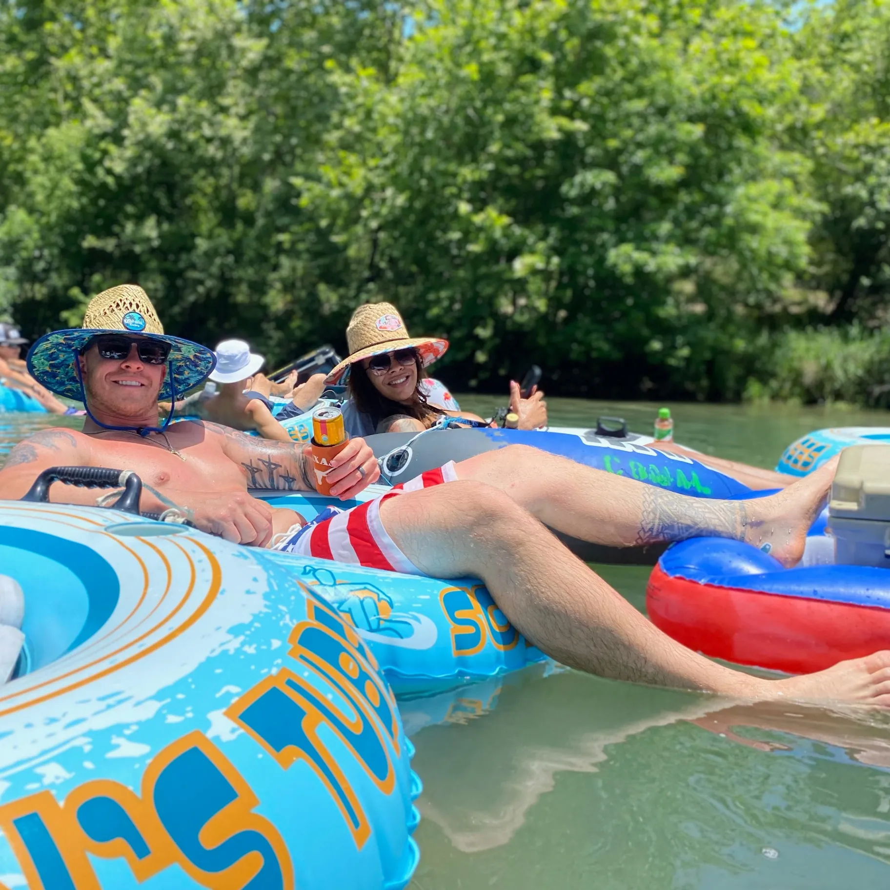 Friends relaxing on tubes in the river