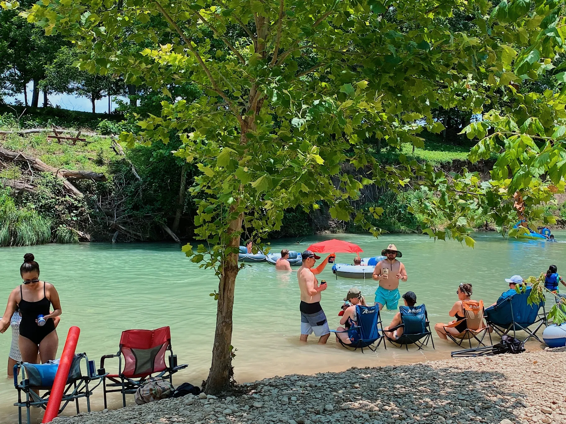 Guests relaxing by the river with chairs