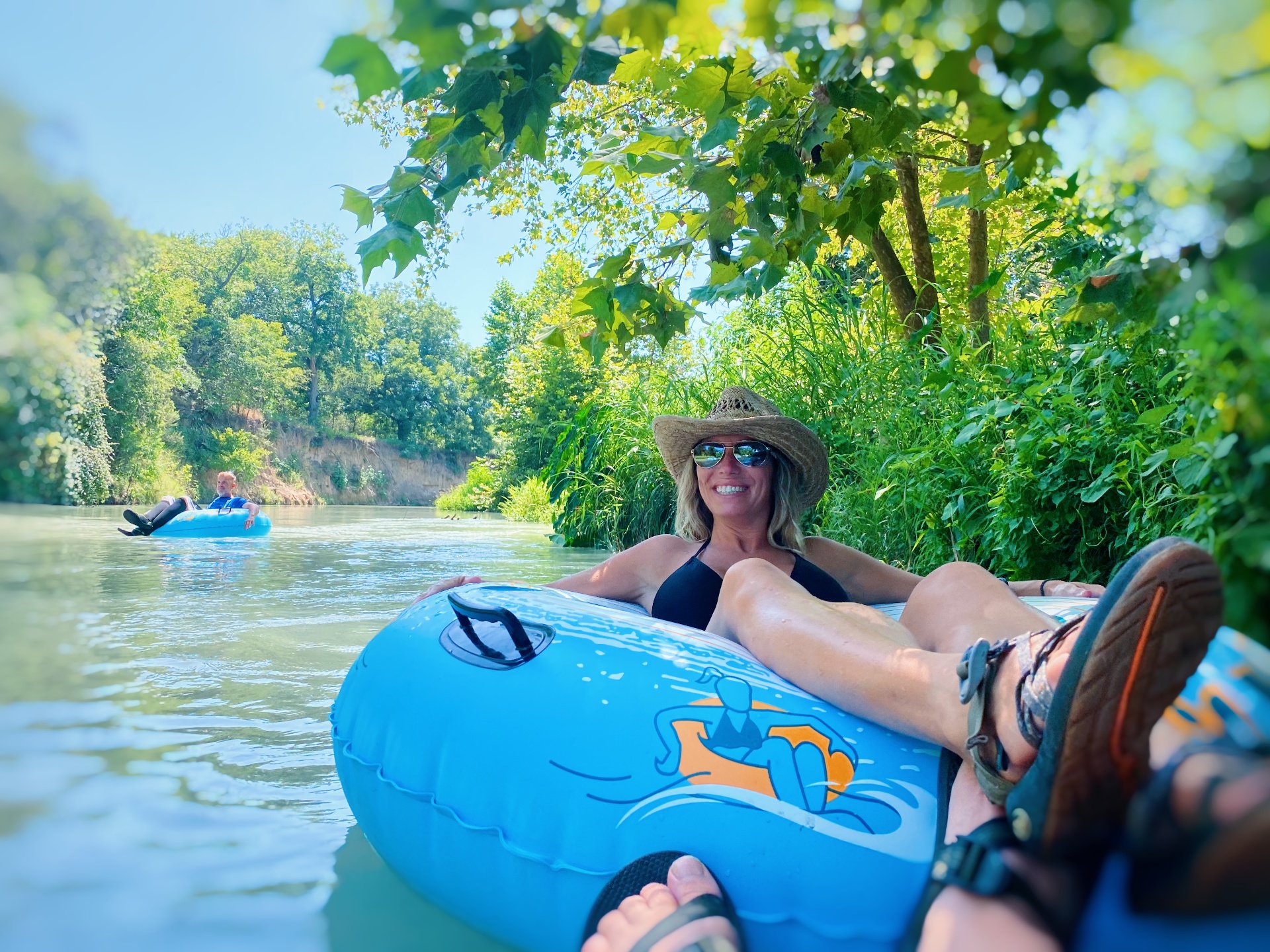 Woman relaxing while tubing on the river