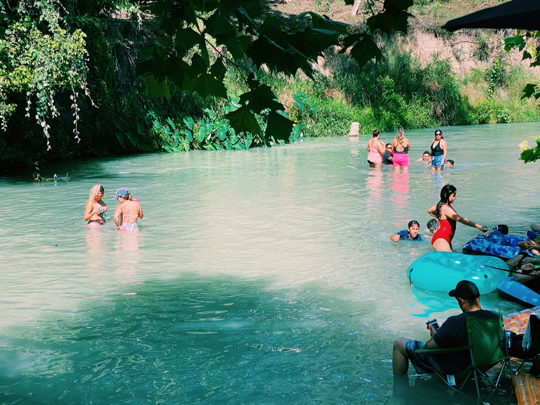 Families enjoying the San Marcos River at Son's Blue River Camp