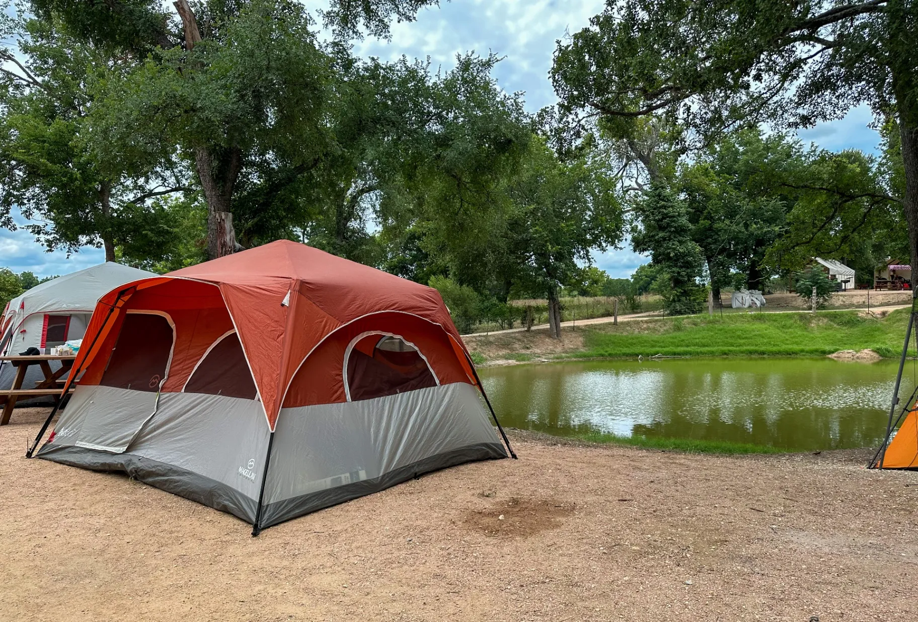Red tent by the pond